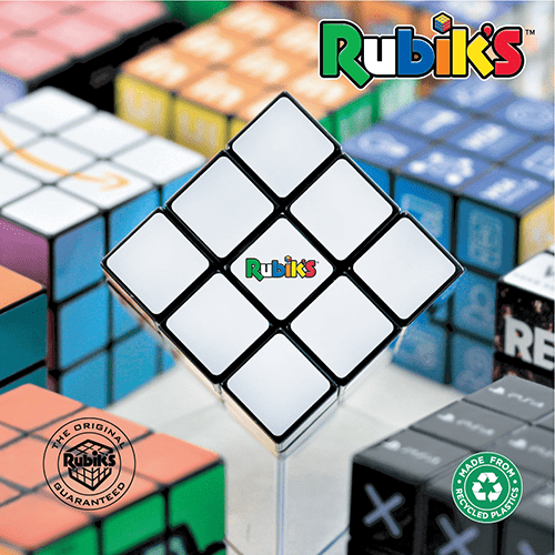 Rubiks Brochure 2023 cover - image is half a dozen Rubik's cubes, some of which have been branded. branded ones are blurred and out of focus and one cube in the centre is the main focus point